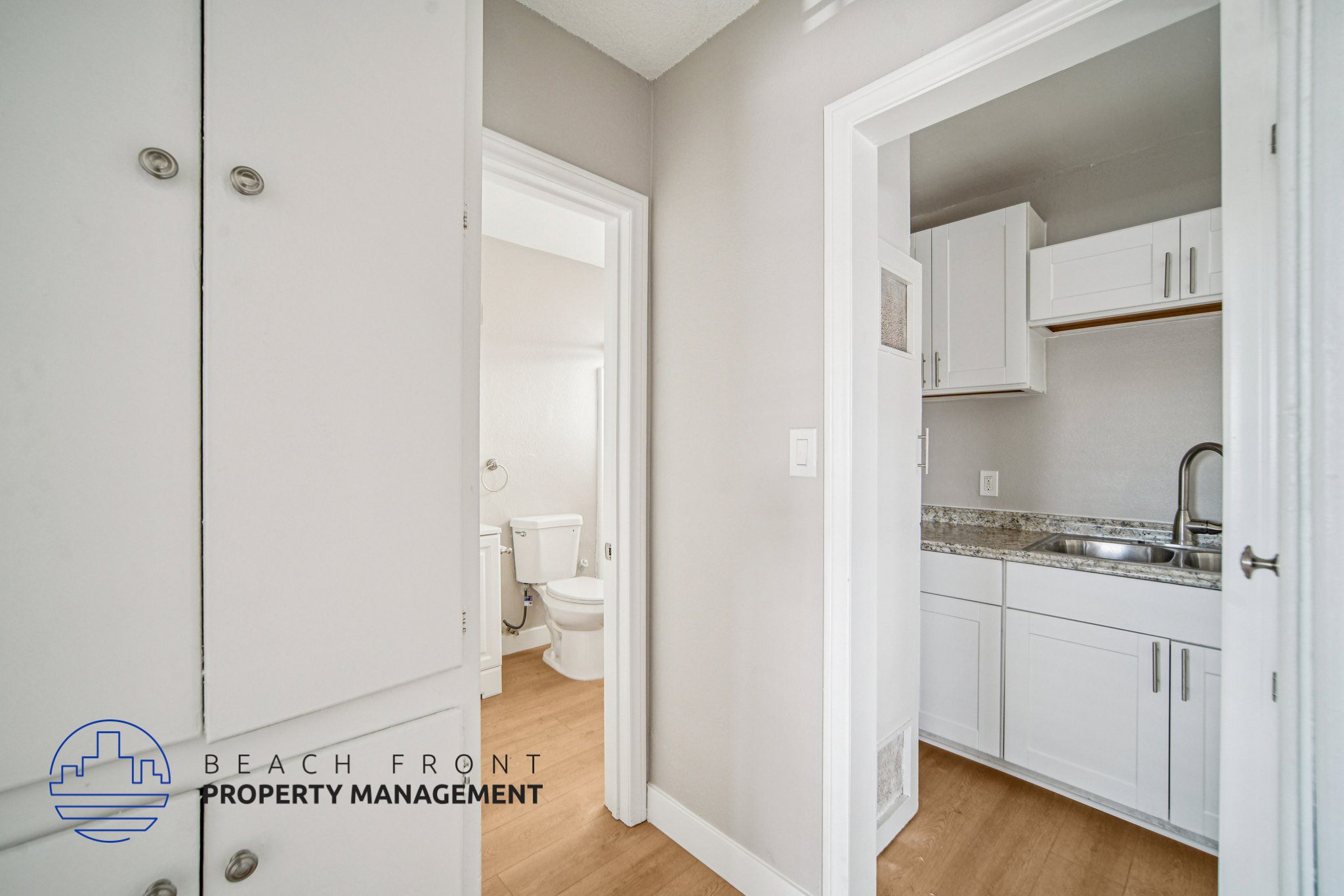 A white bathroom with a toilet and sink.